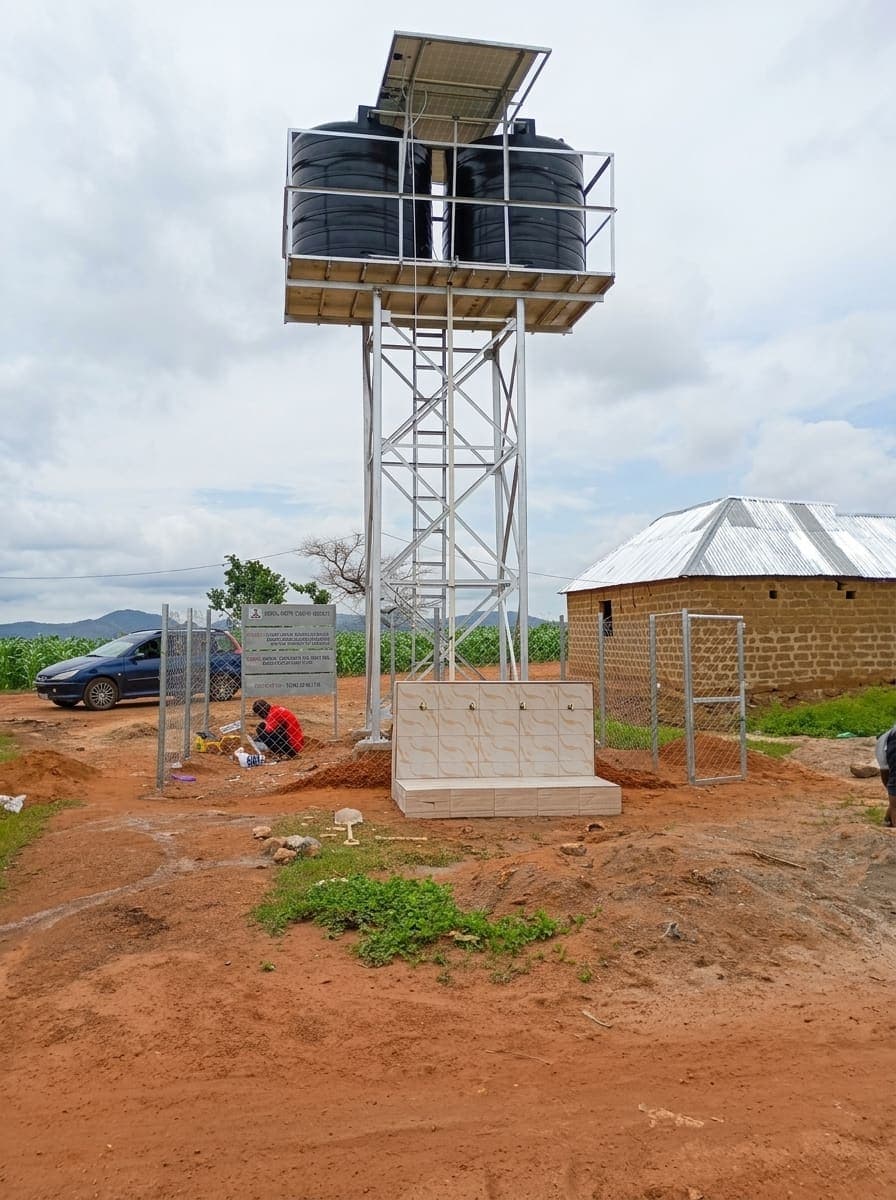 Another of the schemes, the solar array angled above the tank with the pump housing and hardstanding alongside